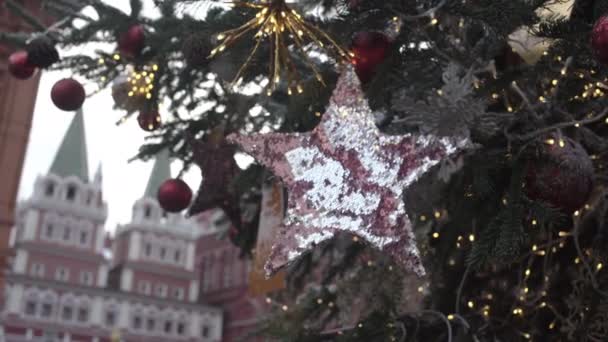 Adornos brillantes cuelgan en el árbol de Navidad con guirnalda amarilla — Vídeos de Stock