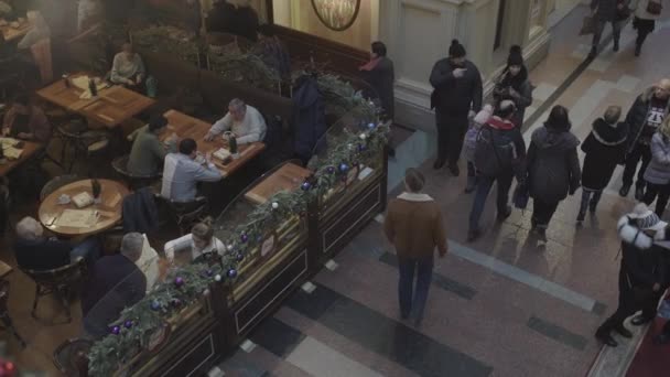 Cidadãos caminham passado pessoas comendo e descansando em restaurante — Vídeo de Stock
