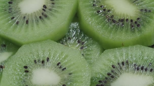 Deliciosas rodajas de kiwi jugosas con pequeñas semillas negras de cerca — Vídeos de Stock