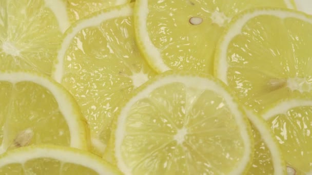 Delicious fresh lemon slices with thin zest macro view — Stock Video