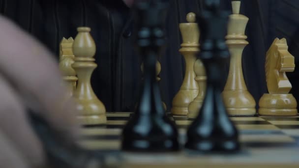 Senior man hands arrange chess pieces on board close view — Stock Video