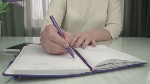 Businesswoman liczy na smartphone pisze w notatniku papierowym — Wideo stockowe
