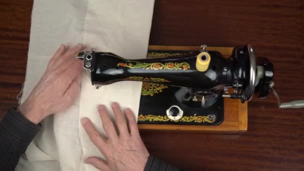 Tailor holds fabric under presser foot and sews dress — Stock Video