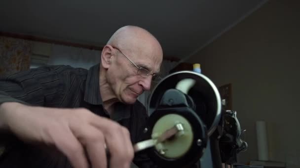 Homem gira volante trazendo máquina para trabalhar com fio — Vídeo de Stock