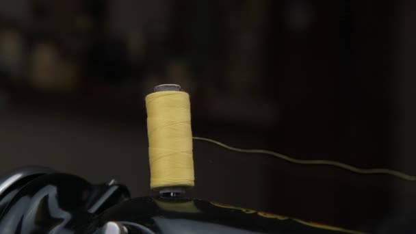 Thread spool turns on pin located on sewing machine top — Stock Video