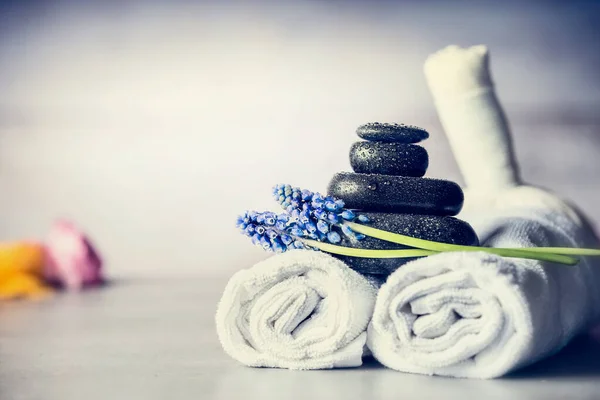 Spa Massage Setting Towels Hot Stones Blue Flowers Close Wellness — Stock Photo, Image