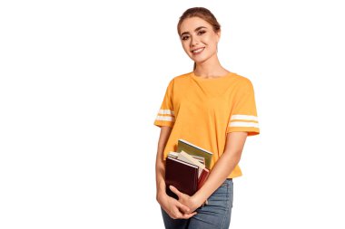 Sarı tişörtlü güzel bir kız öğrenci, elinde kitap ve defter var. Eğitim al, üniversitedeki derslere hazırlan, enstitüye git. Genç mezun. Beyaz arka plan, tecrit. Boşluğu kopyala.