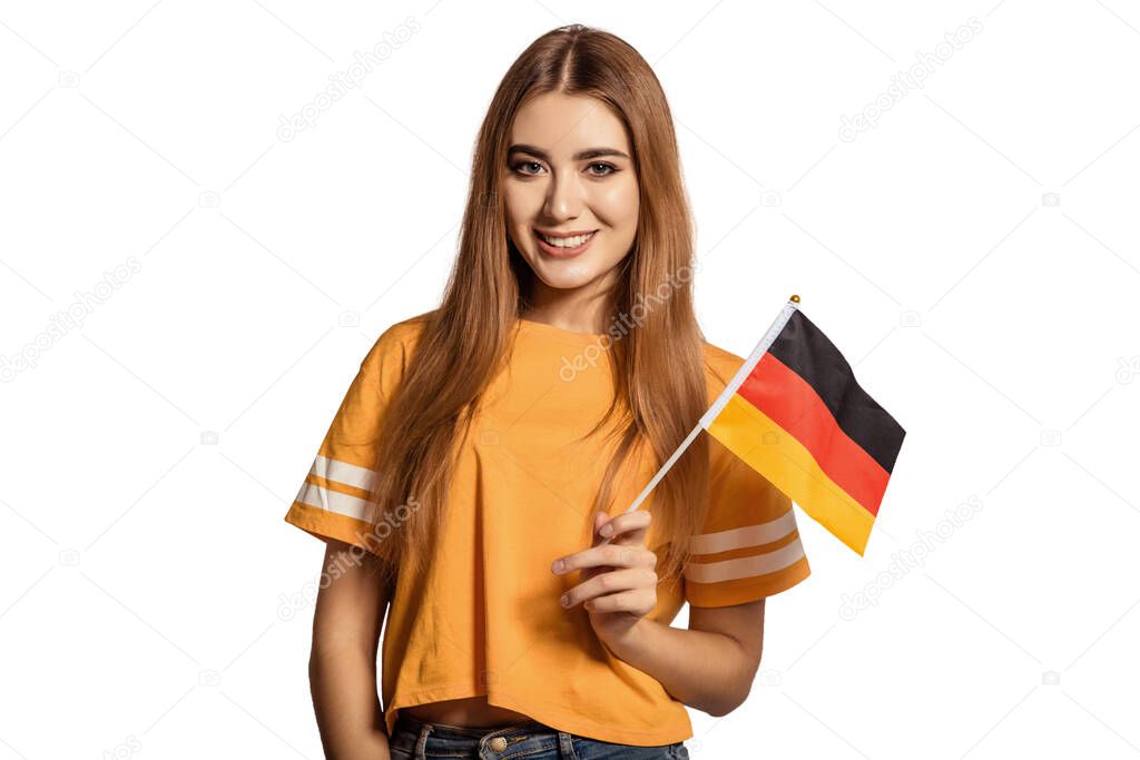 A beautiful young woman holds in her hands the flag of Germany. Exchange student, learn Germanic language. Tourist traveling. White background. Isolate. Football fan.