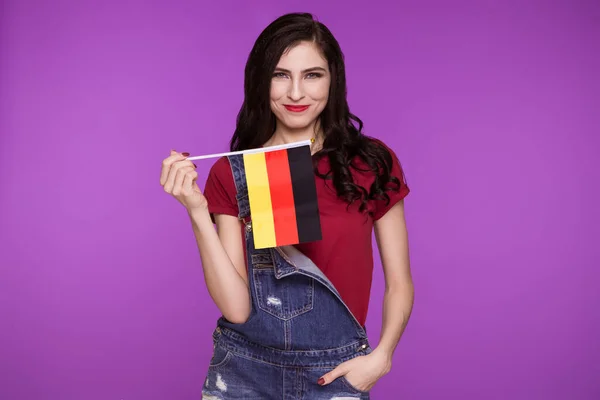 Beautiful Brunette Woman Holding Flag Germany Her Hands Purple Background — Stock Photo, Image