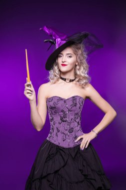 Beautiful woman, blonde in a good witch costume on a purple background holds a magic wand. Costume party, young girl. Halloween clipart