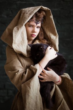 Cadının evcil hayvanı. Genç, güzel bir kız, bir kadın siyah bir kedi tutuyor. Nazik büyücü, medyum. Büyücü öğrenci