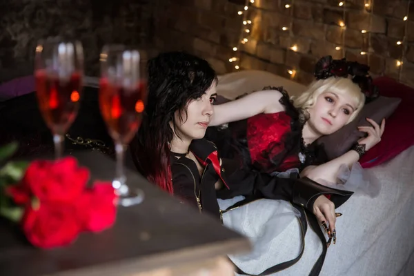 Beautiful woman, girl, blonde lying in bed in a gothic dress next to a vampire, aristocrat, demon. Date. Fairy tale, fantasy.