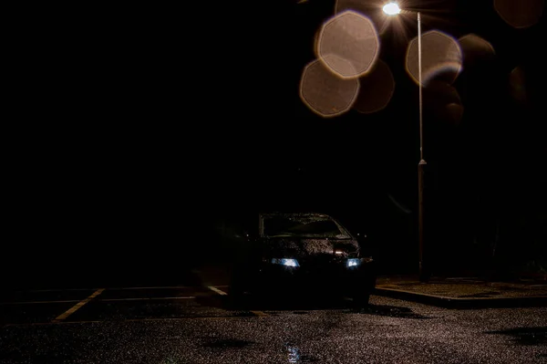 Black Car Headlights Street Light Dark Wet Moody Night — Stock Photo, Image