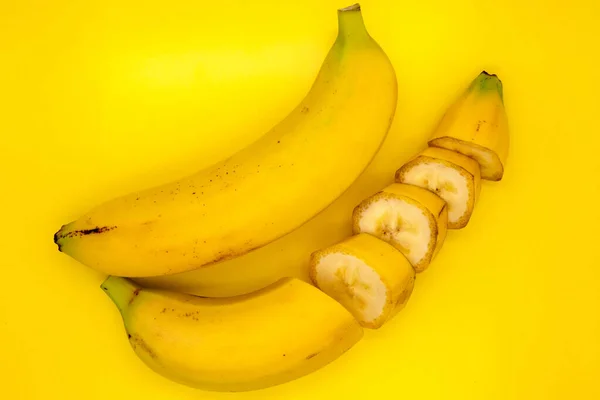 Two sweet banana against light yellow background. — Stock Photo, Image