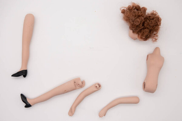 Broken Doll Body Parts on white Background
