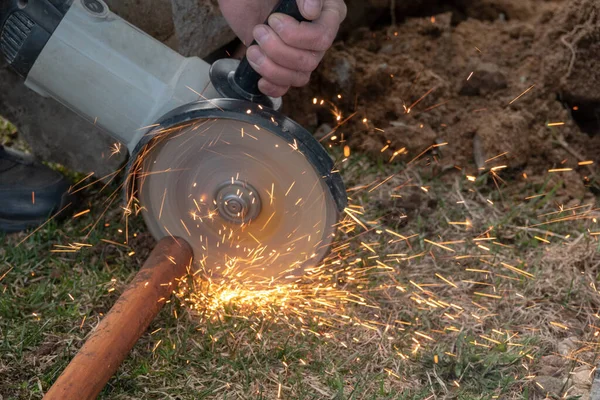 Cut off saw wheel is cutting through a steel pipe