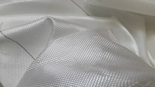 Масляна тканина. Згорнута прозора плівка зі срібною блискіткою і текстом — стокове фото