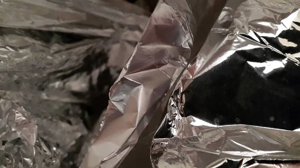 Foil. Crumpled foil. Background of crumpled foil. Creative backg