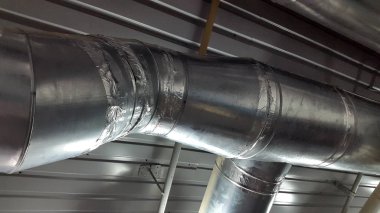 Closeup of pipes on modern plant, industrial background