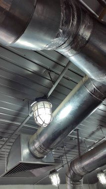 Closeup of pipes on modern plant, industrial background