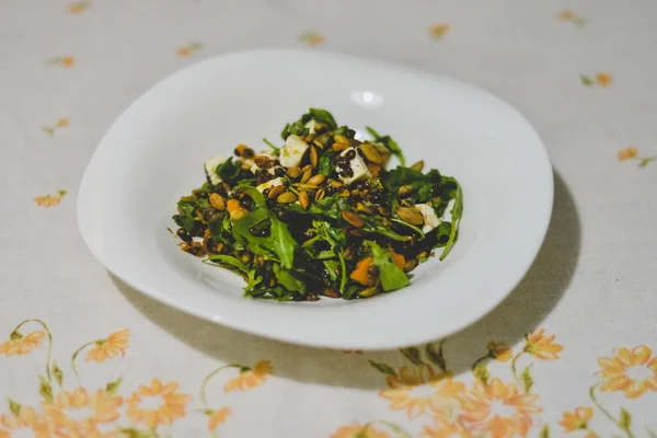 Een plaat met gezonde pompoen en linzen salade op een tabel met grijze tafelkleed. — Stockfoto