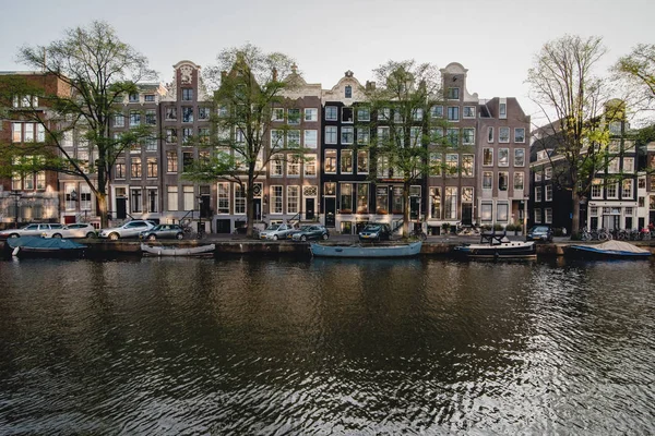 AMSTERDAM - CIRCA JUNE 2017: view of a canal with traditional dutch building facades in the center of Amsterdam, The Netherlands in June 2017. — Stock Photo, Image