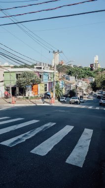 SAO PAULO, BRAZIL - CIRCA SEPTEMBER 2019: hilly landscape and sloping streets in bohemian Vila Madalena neighborhood with a lot of street art in Sao Paulo on a sunny summer day.