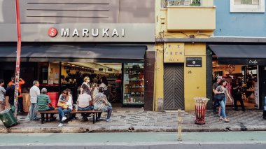SAO PAULO, BRAZIL - CIRCA SEPTEMBER 2019: streets and buildings with many ships in Japantown neighborhood in central Sao Paulo on a sunny day.