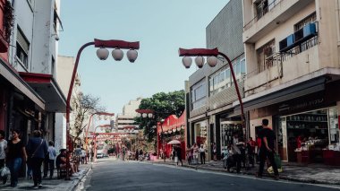 SAO PAULO, BRAZIL - CIRCA SEPTEMBER 2019: streets and buildings with many ships in Japantown neighborhood in central Sao Paulo on a sunny day.
