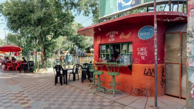 UYUNI, BOLIVIA - CIRCA NOVEMBER 2019: Uyuni 'nin küçük bir kasabasında küçük bir sokakta yeşil yüksek sandalyelerle besinli kırsal eski büfe.