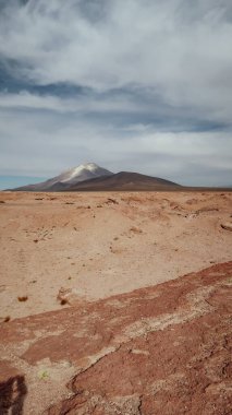 UYUNI, BOLIVIA - CIRCA NOVEMBER 2019: Güneşli bir günde Bolivya Altiplano 'da bulutlu mavi gökyüzü ile terk edilmiş toprak erozyonu.
