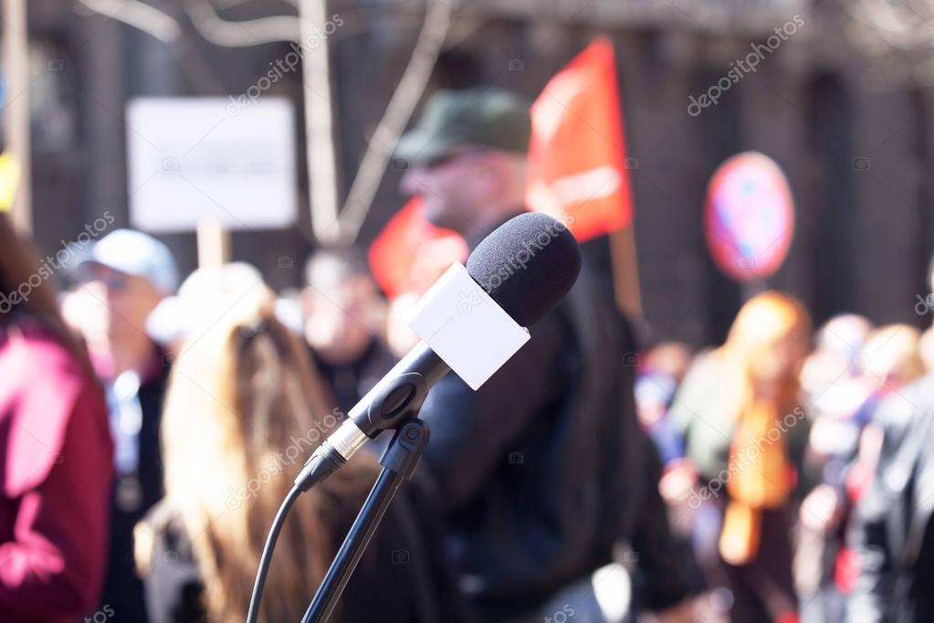 Political protest. Demonstration. Microphone in focus, blurred p