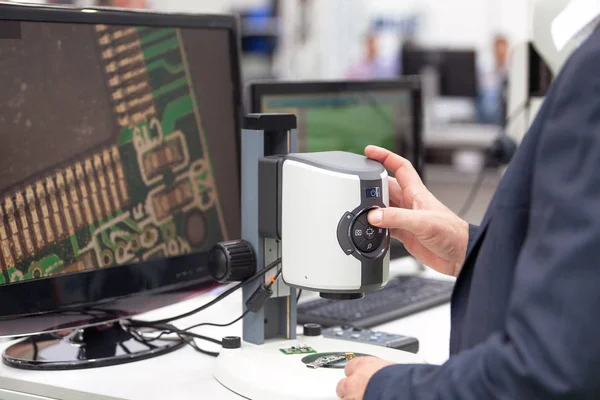 Operator working on digital microscope inspecting electronic component — Stock Photo, Image
