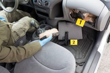 Drug smuggling. Hidden drugs in a vehicle secret compartment clipart