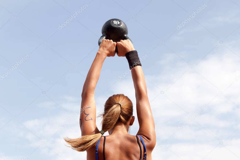 Fitness woman training crossfit with kettlebell