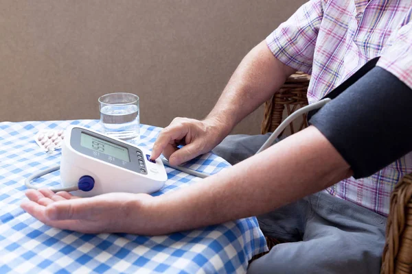 Blood pressure measuring and heart rate checking using digital device — Stock Photo, Image