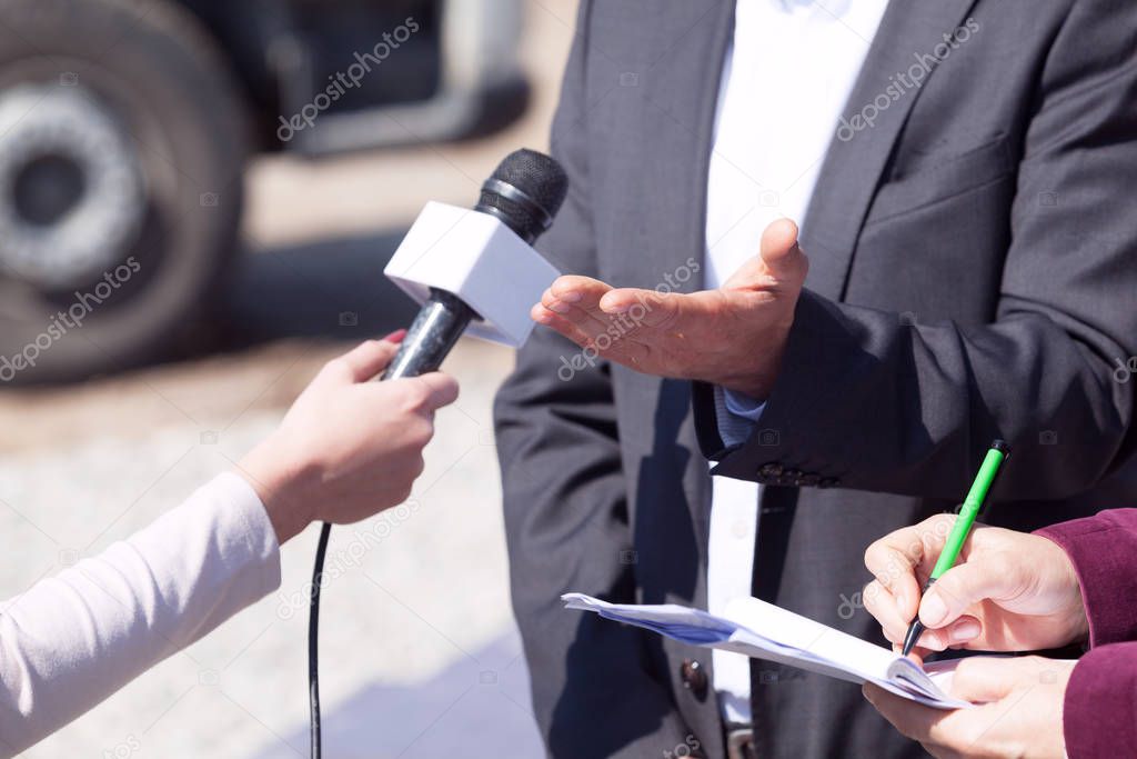 Reporters making media interview with business person or politician