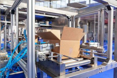 Depo veya dağıtım merkezindeki otomatik paketleme hattında karton paket kutusu