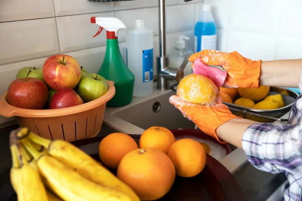 Washing fruits in the kitchen with water and soap