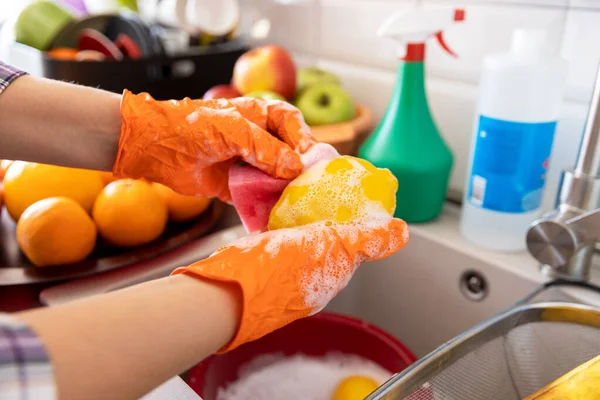 Washing fruits in the kitchen with water and soap