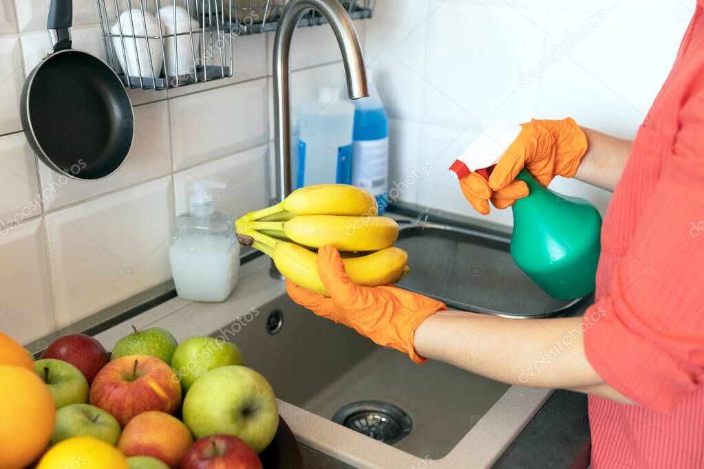Spraying antibacterial chemical on the fruits in the kitchen