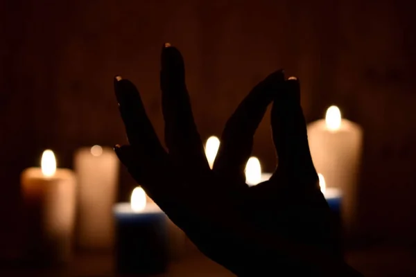 Candles and fingers mudra. Symbol of meditation folded fingers. The figure of the fingers of the mantra. — Stockfoto