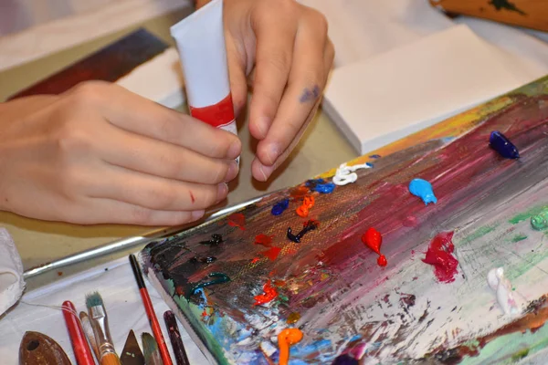 Drawing on canvas with paints. Children's creativity and art