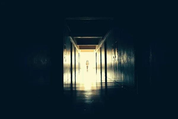 Light at the end of the tunnel. The path to the afterlife. The life after death. Creepy long dark hallway. A Ghost in the tunnel — Stock Photo, Image