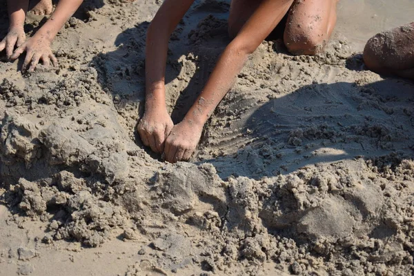 Children build a sand figure. Kids playing on the beach. — 스톡 사진