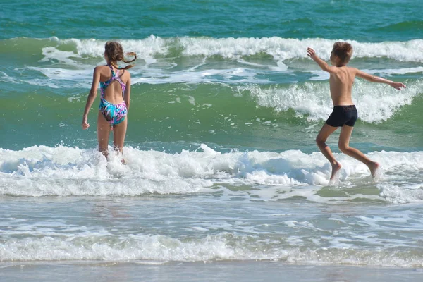 Szczęśliwe dzieci bawią się razem na plaży. — Zdjęcie stockowe