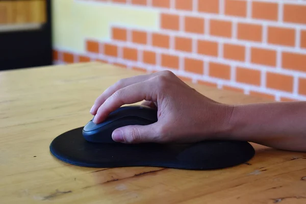 Hand controls a computer mouse. pad for computer mouse.