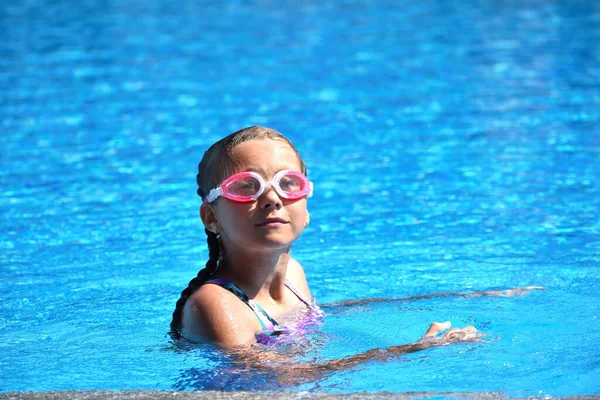 Beautiful little girl swims in the sea — 스톡 사진