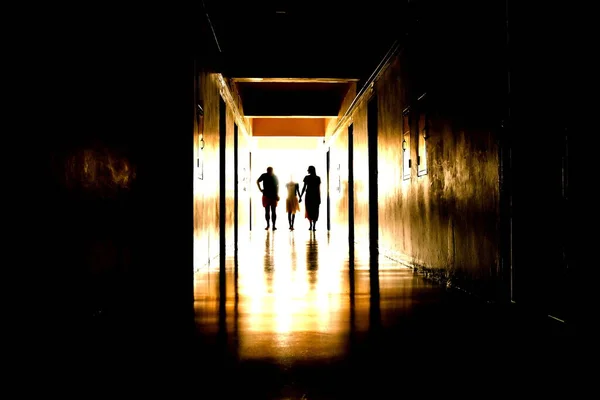 Silhouettes of people in the hallway. A horror movie. The walking dead. The souls of men