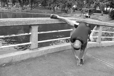 Monochrome photography. A man goes in for sports in Central Park . Health care.